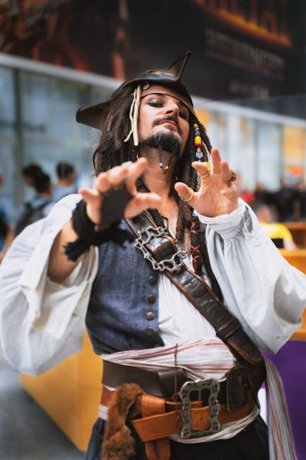 A person in pirate cosplay striking a pose at an indoor event, showcasing a detailed costume.